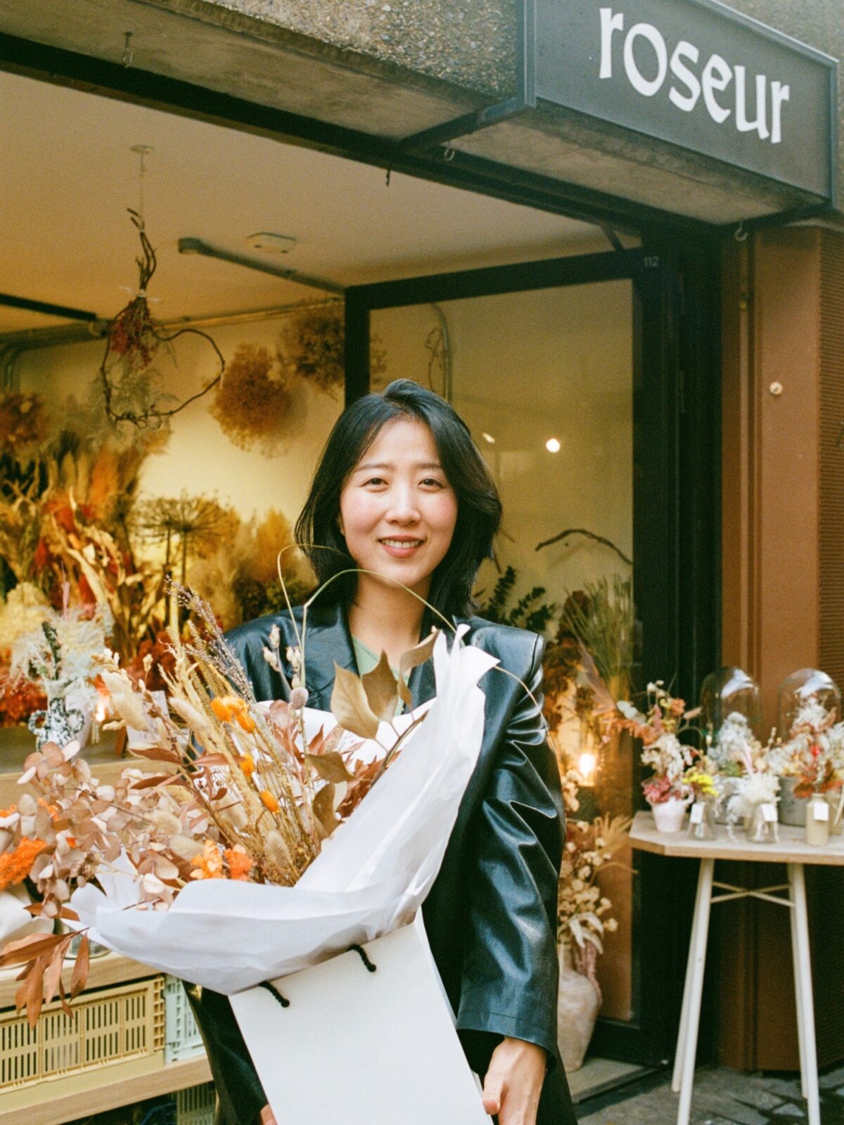 Founder of Roseur standing outside the Roseur store on Lower Stable Street